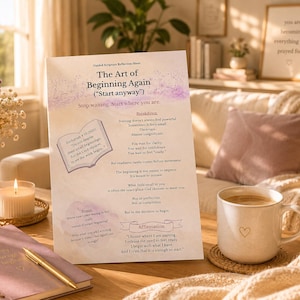 Puede incluir: Una escena acogedora con una hoja impresa titulada "The Art of Beginning Again", una taza de café, un diario y una vela encendida. La hoja tiene texto e ilustraciones. Una impresión enmarcada con texto está en el fondo.