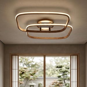 May include: A contemporary dining room with a wooden table set for a meal. A distinctive, layered, geometric light fitting with integrated lighting hangs above. The room has a neutral colour scheme and a view of a Japanese garden.