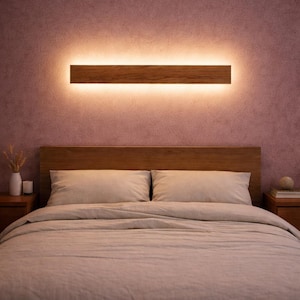 May include: A bedroom with a wooden headboard and neutral-toned bedding. Above the bed, a rectangular wooden wall light provides a warm, ambient glow. The room's colour scheme is soft and muted. The wall light is approximately 90 cm in length.