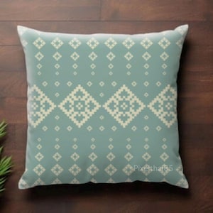 May include: A square throw pillow in a muted sage green color featuring a repeating geometric pattern of cream-colored diamonds and small squares. The design is symmetrical and covers the entire front surface of the pillow in a pixelated style.