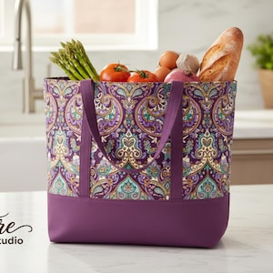 May include: A patterned tote bag with a purple base and handles, filled with groceries such as tomatoes, asparagus, and a baguette. The bag features a decorative paisley pattern. The text "Signature Pattern Studio" is in the lower left corner.