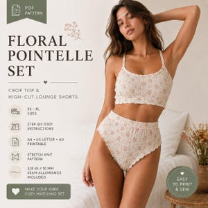 May include: A two-piece floral pointelle set consisting of a crop top and high-cut lounge shorts. The fabric is cream-colored with a delicate floral pattern. Text on the image includes PDF PATTERN, FLORAL POINTELLE SET, CROP TOP & HIGH-CUT LOUNGE SHORTS, XS-XL SIZES, STEP-BY-STEP INSTRUCTIONS, A4, US LETTER, A0 PRINTABLE, STRETCH KNIT PATTERN, and 3/8 IN SEAM ALLOWANCE INCLUDED.