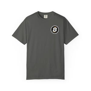 May include: Dark gray t-shirt featuring a Bitcoin logo on the front. The logo is a white "B" inside a black circle, with gold accents. The shirt has short sleeves and a crew neck.
