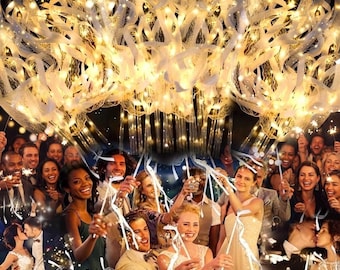 May include: A large, circular chandelier featuring numerous white ribbons and warm, glowing string lights. The fixture emits a bright, golden illumination, creating a festive atmosphere with cascading light strands hanging downward.