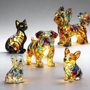 May include: A collection of stained glass animal figurines, including a black cat, a bulldog, a Yorkshire Terrier, and a Corgi. The figurines are illuminated, showcasing a mosaic of vibrant colors and intricate designs. The cat is black, while the dogs are multi-colored.