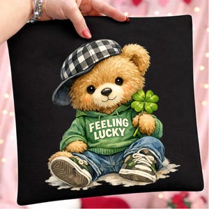 May include: A white ceramic mug with a black handle and the text "But First, Coffee" in a bold, black font. The mug is set against a blurred background, suggesting a cozy setting.