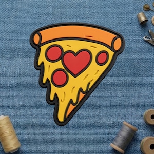 May include: A colorful pizza slice-shaped patch with a heart-shaped pepperoni. The patch features a yellow base with red pepperoni and a black outline. The crust is orange. A fun, food-themed accessory.