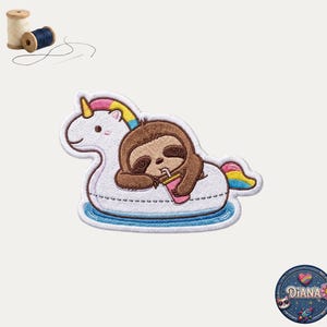 May include: An embroidered patch featuring a brown sloth resting on a white unicorn-shaped pool float with a yellow horn and rainbow tail, holding a pink drink with a straw. Two wooden spools of thread and a needle are visible in the corner.
