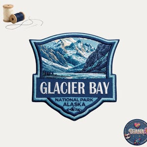 May include: A shield-shaped embroidered patch featuring a detailed landscape of Glacier Bay National Park, Alaska, with snow-capped mountains and water. The text reads GLACIER BAY NATIONAL PARK ALASKA. Includes two spools of thread and a needle.