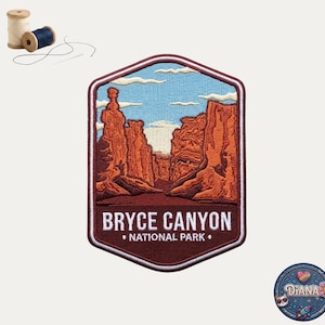 May include: A hexagonal embroidered patch featuring a landscape of Bryce Canyon National Park with orange rock formations, a light blue sky, and white clouds. The text BRYCE CANYON NATIONAL PARK is stitched in white at the bottom of the patch.