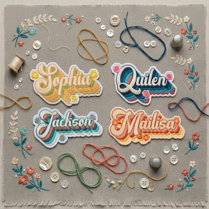 May include: Four embroidered name patches featuring the names Sophia, Quilen, Jackson, and Mailisa in a retro wavy font. The patches are arranged on a gray linen fabric background surrounded by scattered white buttons, thread loops, and floral embroidery.