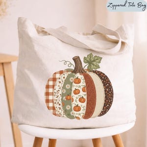 May include: A cream-colored zippered tote bag featuring a large, central graphic of a pumpkin composed of vertical panels. Each panel displays a different pattern, including orange gingham, floral prints, solid textures, and small pumpkin illustrations.