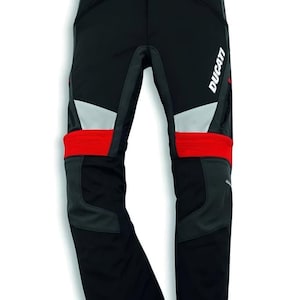 May include: Black motorcycle trousers with red and grey accents. The trousers feature the Ducati logo in white. They have reflective silver panels and are designed for motorcycle riding. The trousers have a Trusted Seller badge.