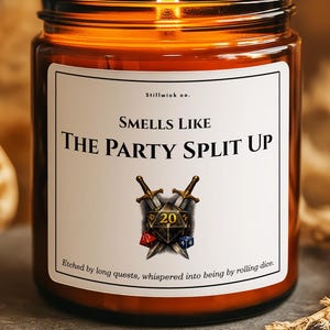 May include: A lit brown glass candle jar with a white label that reads "Smells Like The Party Split Up." The label features crossed swords, dice, and the number 20. The text "Etched by long quests, whispered into being by rolling dice" is also on the label.