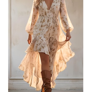 May include: A flowing, cream-colored dress with a floral pattern and a high-low hemline. The dress features long, sheer sleeves and a deep V-neck. Brown leather boots complete the look, creating a bohemian style.
