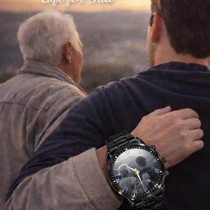 May include: Black wristwatch with a photo of two people on the watch face. The watch has a black metal band and a round face with Roman numerals. The text "Gift for Family, Gift for Dad" is at the top.