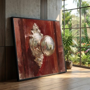 May include: Framed artwork showing a close-up of a door with a shiny silver doorknob. The door is painted in shades of red and brown. The doorknob reflects the surrounding environment. The artwork is displayed in a room with a large window.