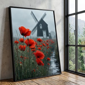 Peut inclure: Une impression d'art encadrée représentant un champ de coquelicots rouge vif couverts de rosée matinale, avec un moulin à vent sombre et rustique se dressant dans un arrière-plan brumeux et couvert. La scène capture un paysage naturel.