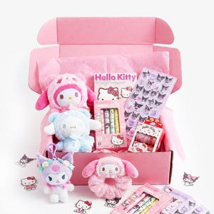 May include: A pink box containing Hello Kitty merchandise, including plush toys, stickers, pens, and decorative tape. The items are in pink, blue, and purple. The box is open, displaying the contents. The box is presented on a white background.