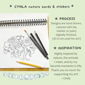 May include: A spiral-bound sketchbook with a floral drawing and the text "Thinking of you." Pencils and a paintbrush are next to the drawing. The text "CYNLA nature cards & stickers" is at the top.
