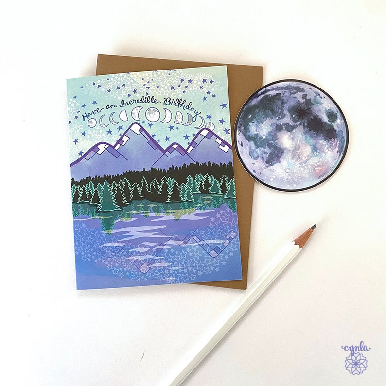 lake forest adventure birthday camping card trees stars wilderness outdoor lover sticker card hiker May include: A greeting card with a blue, purple, and green mountain scene with a lake reflection. The card has the text "Have an incredible Birthday" with a moon and stars design.