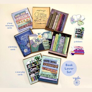 May include: A book lover set featuring greeting cards and stickers. The set includes cards with book and floral designs, and stickers with teacups and bookshelves. The text on the cards includes "Once upon a time" and "The Most Amazing Year".
