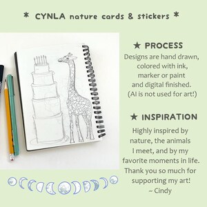 May include: A spiral-bound sketchbook with a pencil and pen next to it. The open page features a detailed pencil sketch of a giraffe and a multi-tiered cake. Text at the top reads "CYNLA nature cards & stickers". Additional text describes the art process and inspiration.