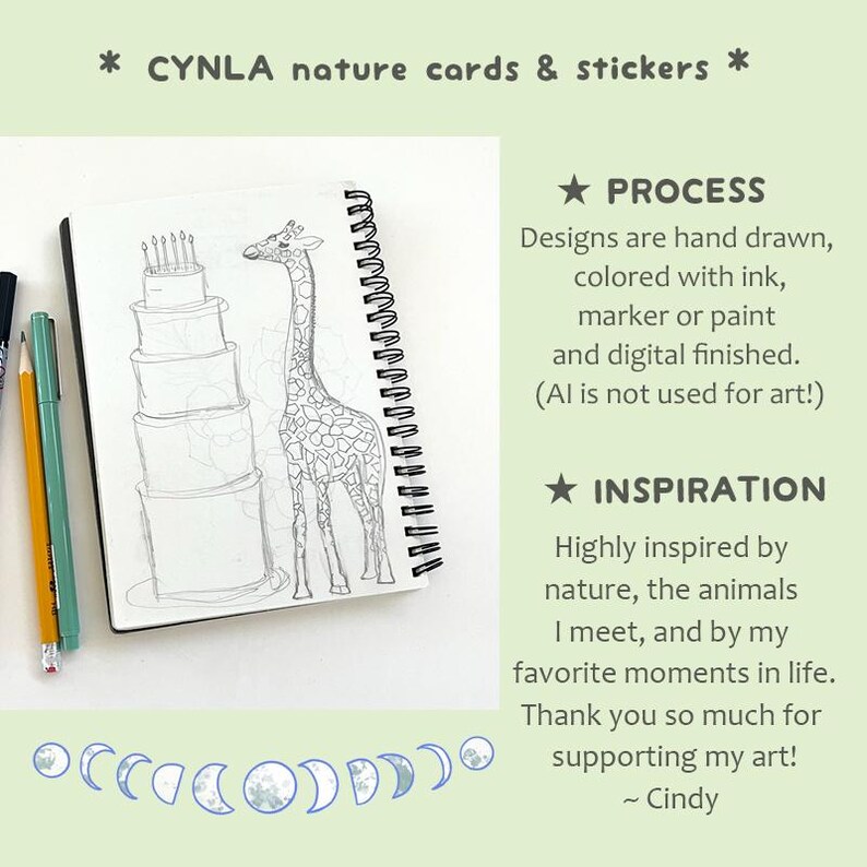 May include: A spiral-bound sketchbook with a pencil and pen next to it. The open page features a detailed pencil sketch of a giraffe and a multi-tiered cake. Text at the top reads "CYNLA nature cards & stickers". Additional text describes the art process and inspiration.