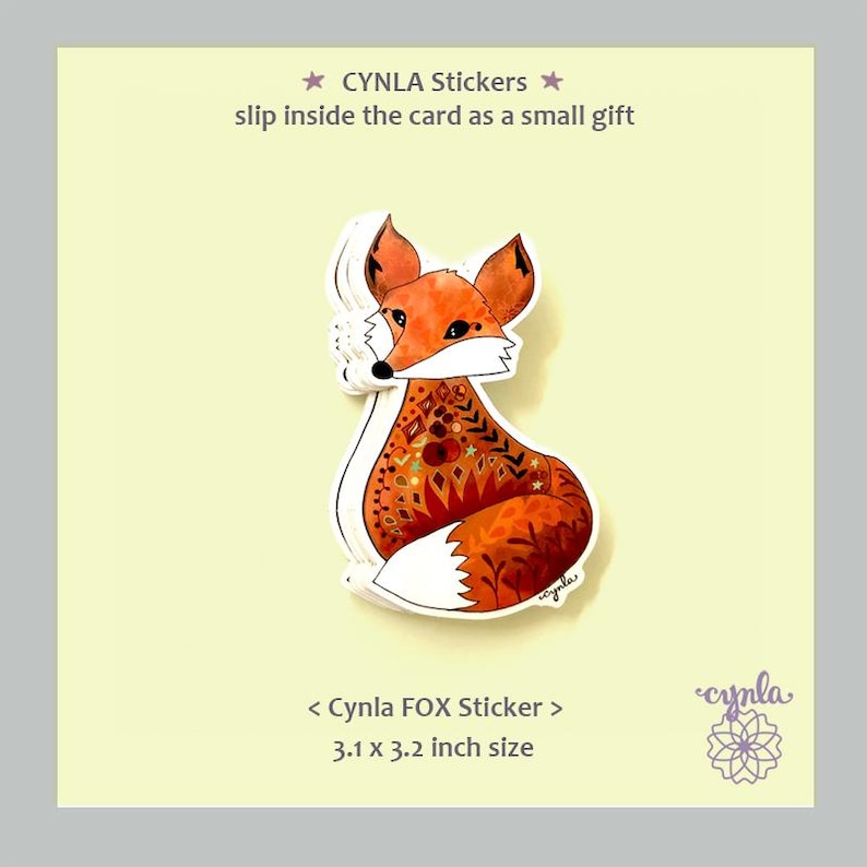 May include: A sticker featuring a stylized fox with orange, brown, and white coloring. The fox has intricate patterns on its body. The sticker is labeled "Cynla FOX Sticker" and measures 3.1 x 3.2 inches. Text above reads "CYNLA Stickers slip inside the card as a small gift."