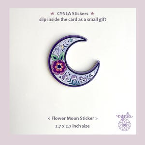 May include: A purple, floral-decorated crescent moon sticker. The sticker has a dark purple border and features a central flower design with pink, purple, and green accents. The sticker is 2.7 x 2.7 inches and is labeled "Flower Moon Sticker."