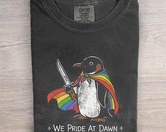 We Pride At Dawn Shirt, Funny Penguin Pride Month Tee, Rainbow Cape Knife LGBTQ Gift, Retro Creative Penguin Graphic Comfort Pepper T-shirt