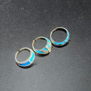 Back view of turquoise enamel rings with gold tone finish, showing band details and craftsmanship.