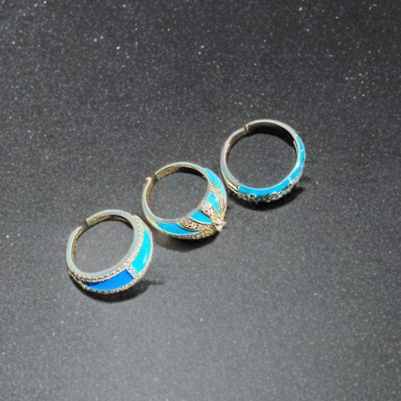 Back view of turquoise enamel rings with gold tone finish, showing band details and craftsmanship.