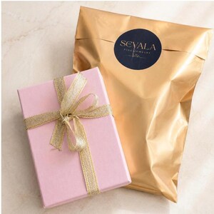 Sevala Jewelry gift packaging with pink gift box, gold pouch and elegant gift presentation.