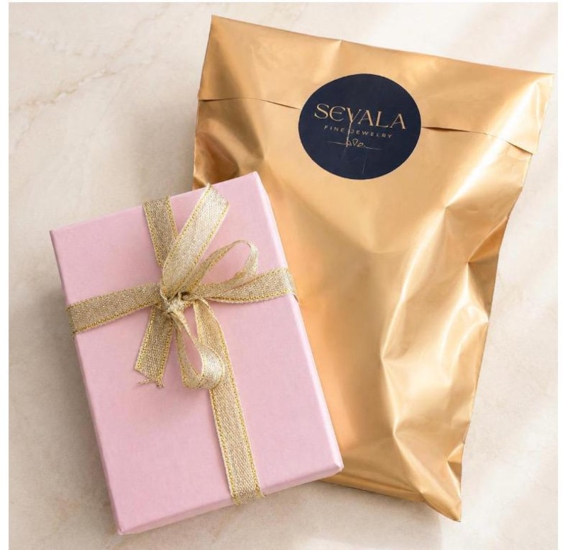 Sevala Jewelry gift packaging with pink gift box, gold pouch and elegant gift presentation.