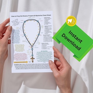 May include: A person holds a printed guide titled "How to Pray the Rosary: Prayers & Mysteries Cheat Sheet". The guide features a diagram of a rosary and lists prayers. A green "Instant Download" sticker is visible.