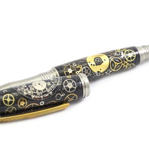 May include: A steampunk-style pen with a black and silver body, adorned with intricate gold and silver gears. The pen's design includes a clock face and a metallic tip, showcasing a blend of industrial and artistic elements.