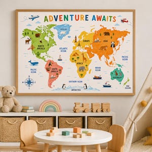 May include: A rectangular wall poster featuring a colourful world map with the text ADVENTURE AWAITS at the top. The map displays continents in distinct colours, labelled with names, oceans, and various animal and landmark illustrations.