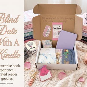 May include: An open cardboard box containing a light purple e-reader, a small tin with a green cartoon graphic, a pair of white socks with blue patterns, a pink envelope-shaped keychain with a tassel, and a card with the text Tap Keeps.