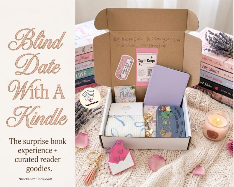May include: An open cardboard box containing a light purple e-reader, a small tin with a green cartoon graphic, a pair of white socks with blue patterns, a pink envelope-shaped keychain with a tassel, and a card with the text Tap Keeps.