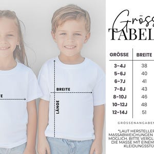 May include: A size chart for children's t-shirts featuring a table with columns for size, width, and length in centimeters. The chart lists sizes from 3-4J to 12-14J with corresponding measurements, noting a potential variance of plus or minus 2 cm.