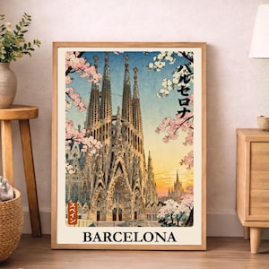 May include: A framed art print depicting the Sagrada Familia in Barcelona, Spain, with cherry blossoms in a Japanese style. The print includes the word "BARCELONA" and Japanese text.