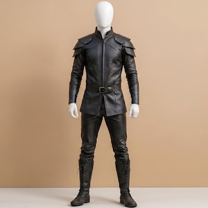 May include: A black leather outfit consisting of a long-sleeved jacket with layered shoulder pauldrons, a high collar, and a front zip. The ensemble includes matching black leather trousers and tall black lace-up boots with a belt at the waist.