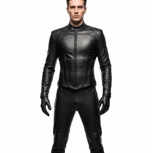 May include: A black leather jacket with a stand-up collar and a front zip. The jacket has a fitted shape and is worn with matching black leather trousers and gloves. The outfit is sleek and modern.