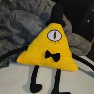 May include: A white ceramic mug with a black handle and the text "But First, Coffee" in a bold, black font. The mug is set against a blurred background, suggesting a cozy setting. The mug appears to be approximately 4 inches tall.