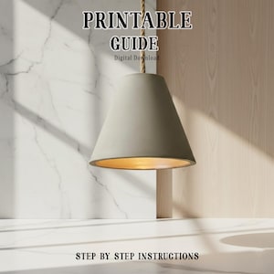 May include: A gray cone-shaped pendant light with a gold interior hangs from a rope. The text "PRINTABLE GUIDE" and "Digital Download" is at the top. The text "STEP BY STEP INSTRUCTIONS" is at the bottom.