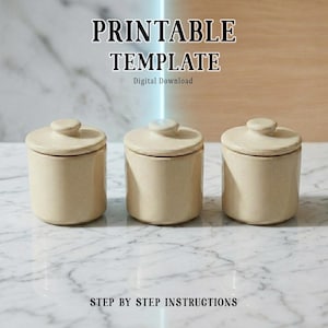 May include: Three beige ceramic jars with lids are arranged on a marble surface. The jars are cylindrical with a small, round knob on top of each lid. The text "PRINTABLE TEMPLATE" and "STEP BY STEP INSTRUCTIONS" are visible.