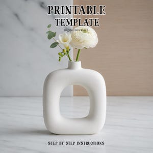 May include: A white ceramic vase with a square cut-out, containing white flowers and foliage. The text "PRINTABLE TEMPLATE" and "STEP BY STEP INSTRUCTIONS" are displayed above and below the vase. "Digital Download" is also displayed.