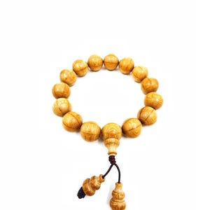 May include: A white ceramic mug with a black handle and the text "But First, Coffee" in a black, bold font. The mug is on a wooden surface.