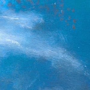 May include: A textured canvas painting featuring a deep blue background with a prominent white diagonal brushstroke across the center. The upper section displays scattered dark and orange paint splatters. The signature MaJoBa is in the bottom corner.